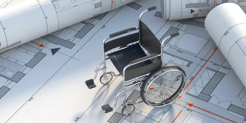 Fauteuil roulant sur un plan de construction accessible aux personnes à mobilité réduite respectant les conditions du label Handibat